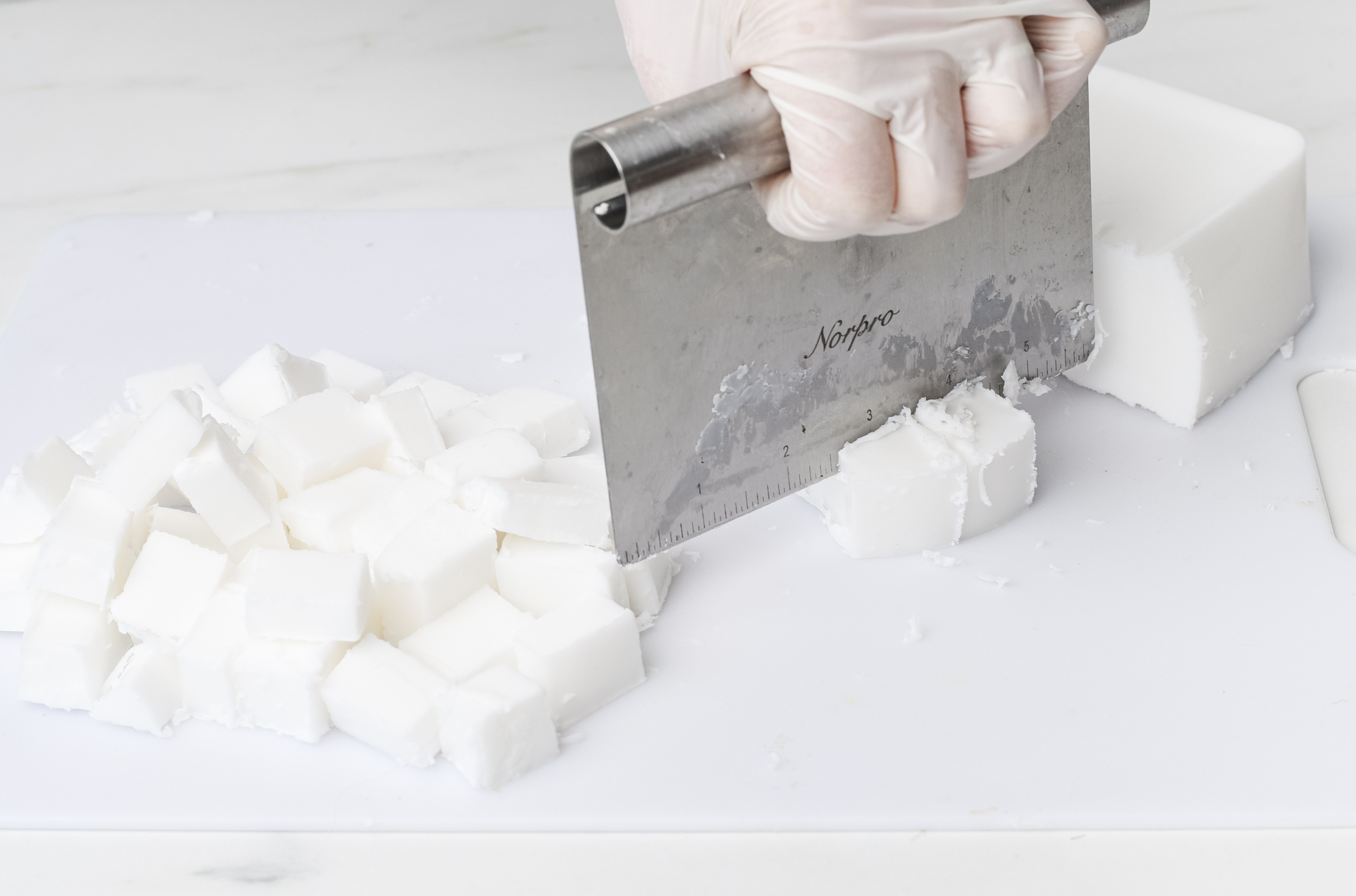 Cutting soap block into cubes.