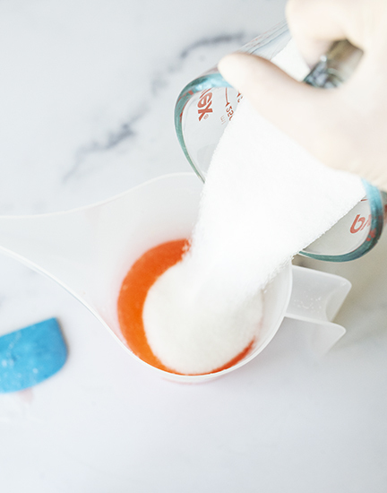 Adding sugar to soap mixture.